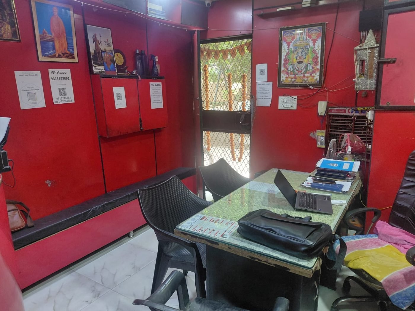 Arya Samaj Mandir Delhi court marriage office interior — laptop, advocate desk, Swami Dayanand portrait